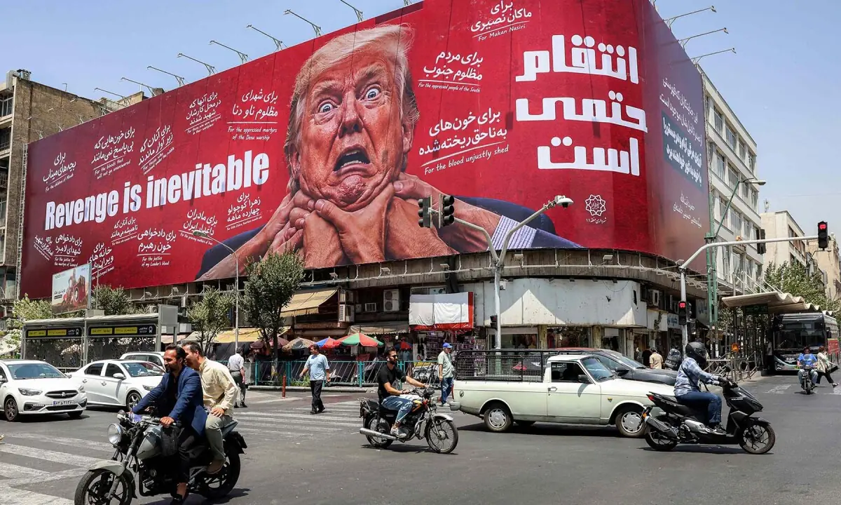 Motorists drive past a large billboard pledging revenge against US President Donald Trump along Jomhouri Street in central Tehran, Iran on July 27, 2026. &mdash; AFP