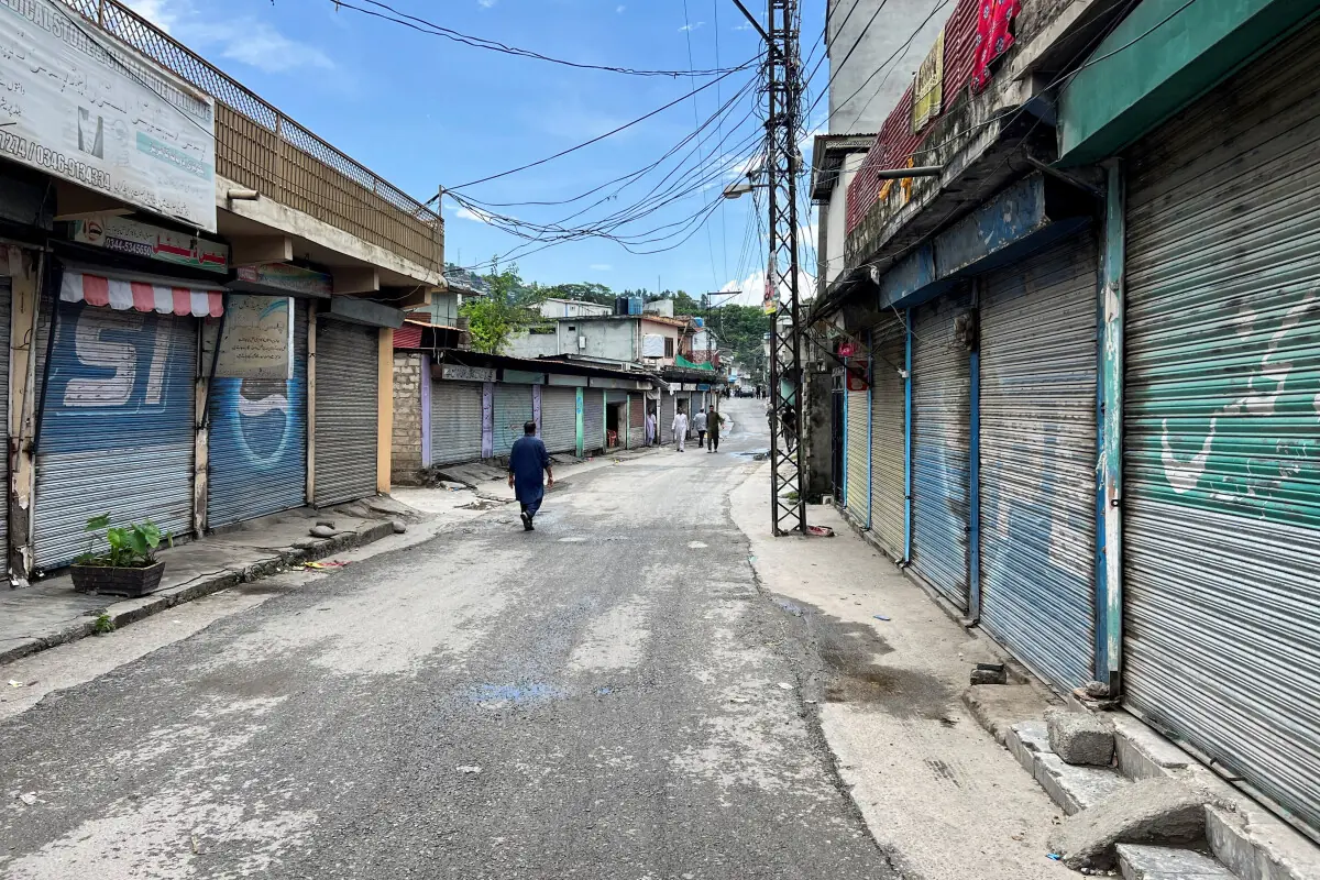  A person walks past closed shops at a market, during the second phase of the Azad Jammu and Kashmir (AJK) Legislative Assembly elections, in Muzaffarabad on August 2. &mdash; Reuters 