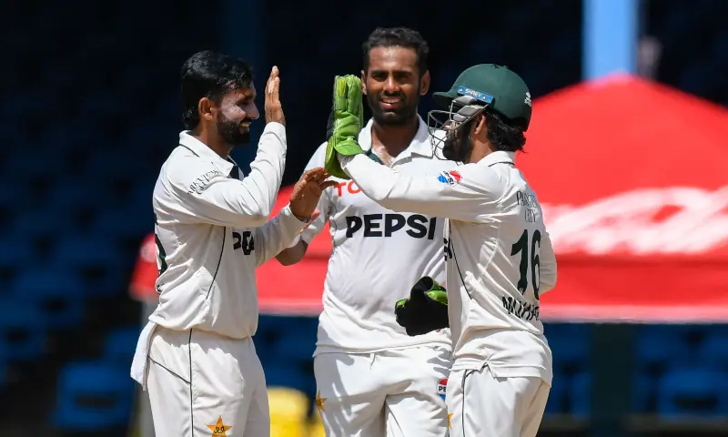 Ali Usman (L), Mohammad Ali (C) and Mohammad Rizwan (R) of Pakistan celebrates the dismissal of Shamar Joseph of West Indies during the 4th day of the 2nd Test match between West Indies and Pakistan at Queens Park Oval, Port of Spain, Trinidad and Tobago, on August 5, 2026. — AFP