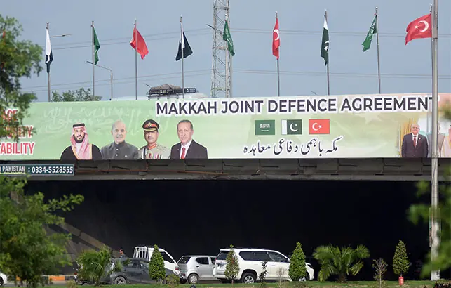A billboard on a pedestrian bridge in Faizabad displays portraits of Saudi Crown Prince Mohammed bin Salman, Prime Minister Shehbaz Sharif, Chief of Defence Forces Field Marshal Syed Asim Munir and Turkish President Recep Tayyip Erdogan as part of celebrations for the signing of the Makkah Joint Defence Agreement, in Islamabad on Sunday. — Online