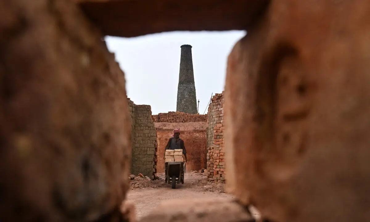 'Work is work, it has to be done': Brickmakers in Pakistan scorched by sun above and fire below
