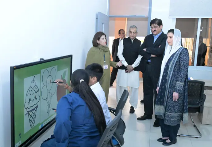 MNA Aseefa Bhutto-Zardari admires, alongside Chief Minister Murad Ali Shah, an artwork being made by a child at the facility.—Dawn