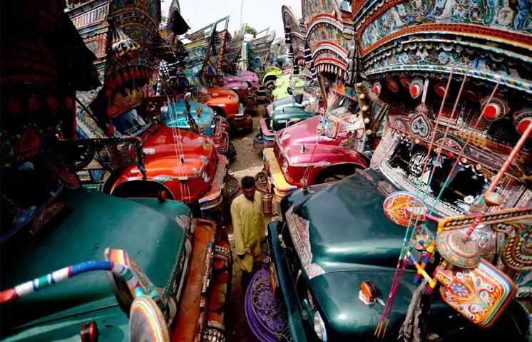 KARACHI: A driver passes between trucks parked at the Shireen Jinnah colony terminal, as a wheel-jam strike called by goods transporters affected the movement of cargo across the country for a third consecutive day. Talks between transporters and the government are expected to continue today.—PPI