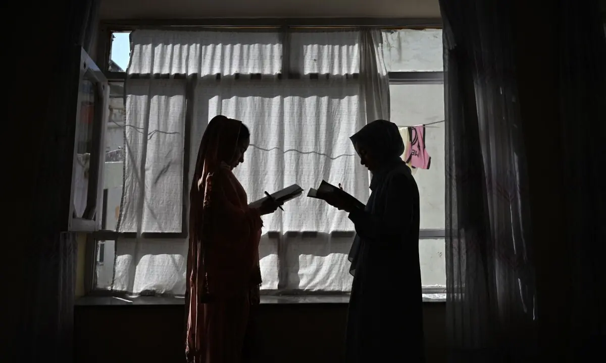 This photograph taken on August 6, 2026 shows Afghan girls attending a lesson by their father at their residence in Kabul. —AFP/File