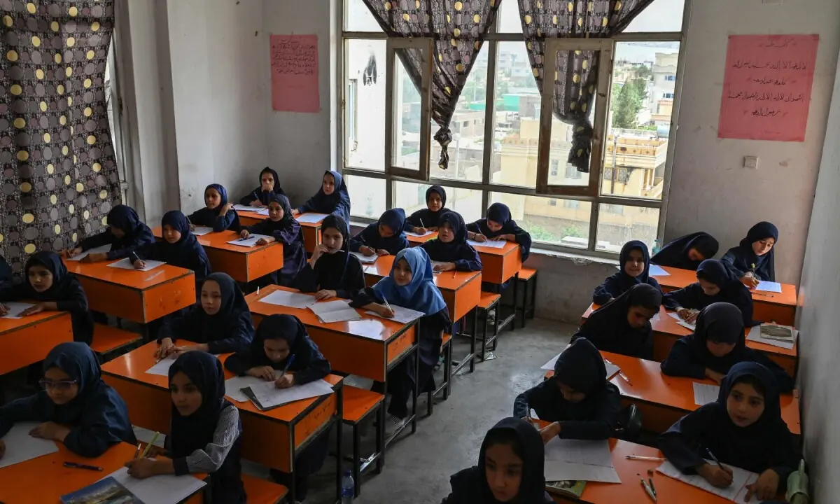 This photograph taken on July 21, 2026 shows Afghan girls taking their midterm exams at a primary school in Kabul. —AFP/File