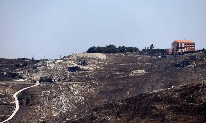 A photograph taken from the southern Lebanese viallage of of Zawtar al-Gharbiyah shows Israeli troops stationed in the nearby village of Zawtar al-Charkiyah on August 11, 2026. &mdash;AFP
