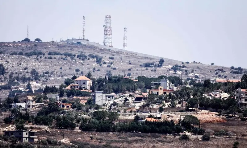 A photograph taken from the southern Lebanese village of Chaqra shows destruction in the border village of Houla, and behind it what is know as the &lsquo;Abbad Israeli outpost&rsquo; on August 11, 2026. &mdash;AFP