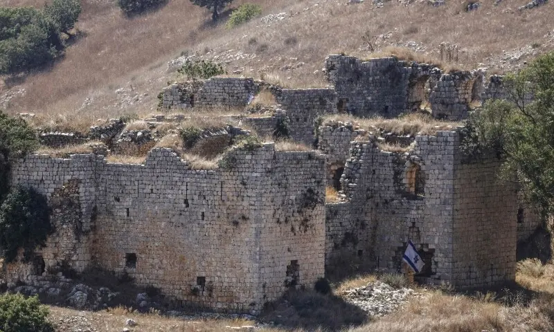 A photograph taken from the southern Lebanese village of Chaqra shows the Israeli flag staked at the nearby Crusaders Cital of Doubieh on August 11, 2026. &mdash;AFP
