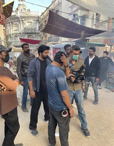 Director Fajr Raza (centre) at a shoot with his production crew