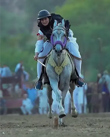   Anum Shakoor positions herself with the lance as she gallops towards the peg atop her horse Shehzada during a mela in Padshahan, Chakwal, on June 14, 2026 | Courtesy Anum Shakoor 