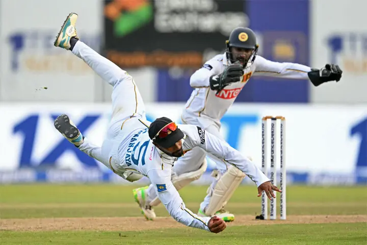 SRI LANKAN captain Dhananjaya de Silva takes a catch to dismiss Indian batter Dhruv Jurel during the first Test at the Galle International Stadium on Sunday.—AFP