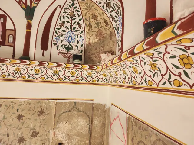 The restored ceiling and walls reveal original artwork and an architectural landscape reflecting the multicultural character of pre-Partition Punjab.