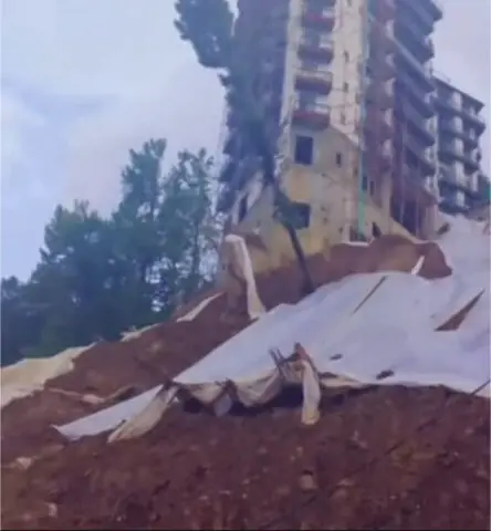   A view of the landslide near a multi-storey building in Galiyat. &mdash; Dawn 