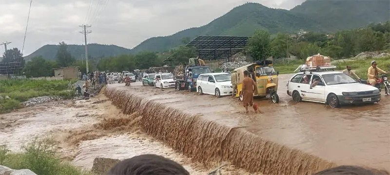 Rainwater inundates Inayat Kallay-Shagoo Road after heavy rain in Bajaur on Thursday. — Photo by Anwarullah Khan