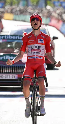 TEAM UAE’s Slovenian rider Tadej Pogacar celebrates as he crosses the finish line to win the fourth stage of the Vuelta a Espana on Tuesday.—AFP