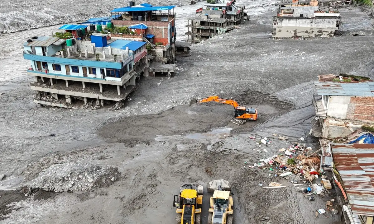 An aerial view shows workers using excavators to clear sludge following flash floods at Trishuli in Nepal&rsquo;s Nuwakot district on August 27, 2026. &mdash;AFP