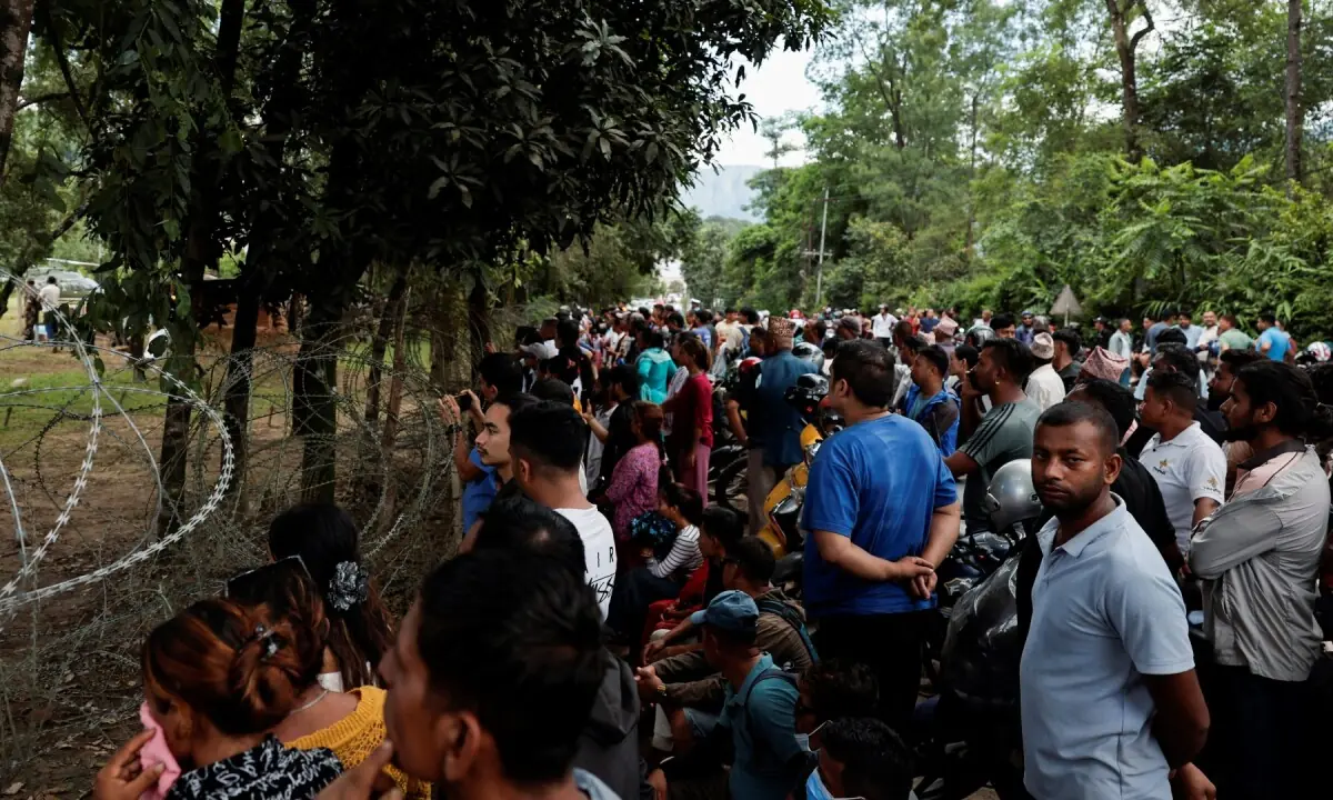 People gather as flood-affected people are brought to Maithali Barrack, an army training centre, which serves as a primary base, after being rescued and airlifted following flash floods and mudslide at Trishuli in Nuwakot district, Nepal on August 27, 2026. &mdash;Reuters