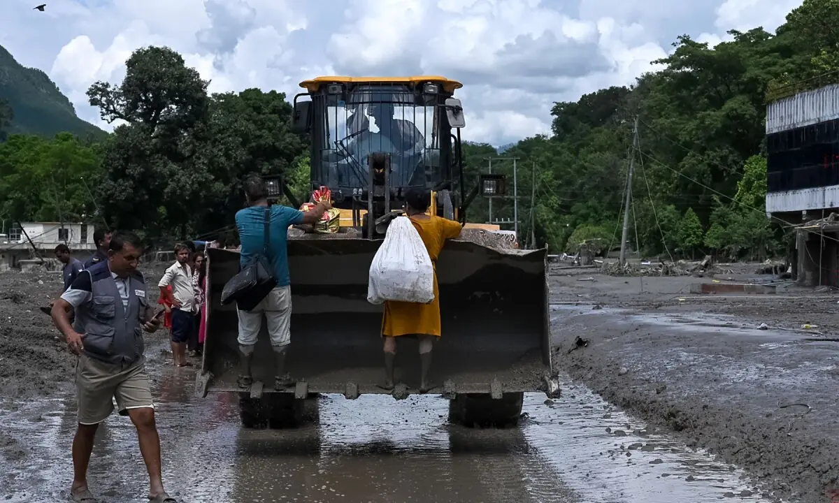 Rescue personnel transport stranded residents using a bulldozer after flash floods in the Devighat area in Nepal&rsquo;s Nuwakot district on August 27, 2026. &mdash;AFP
