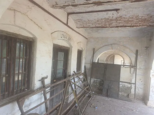 Dismantled iron fixtures lie piled up in the veranda of the waiting room while its roof lies in a dilapidated state.