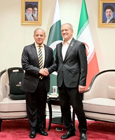 PM Shehbaz Sharif shakes hands with Iranian President Masoud Pezeshkian on the sidelines of the SCO Council of Heads of State meeting in Bishkek.— X/@kbsalsaud / APP / Reuters