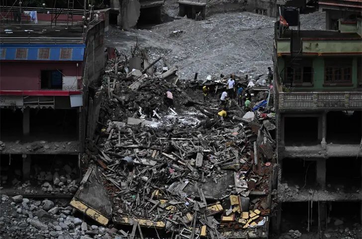 NUWAKOT (Nepal): People work to salvage material from the Trishuli Centre building, which was destroyed in last month’s deadly Himalayan flash floods that claimed 1,252 lives.—AFP