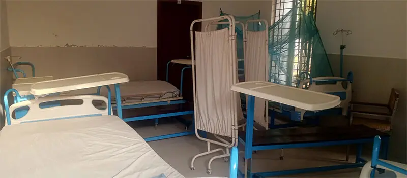 Beds and other medical equipment gather dust and deteriorate as the facility remains without a doctor and patients.