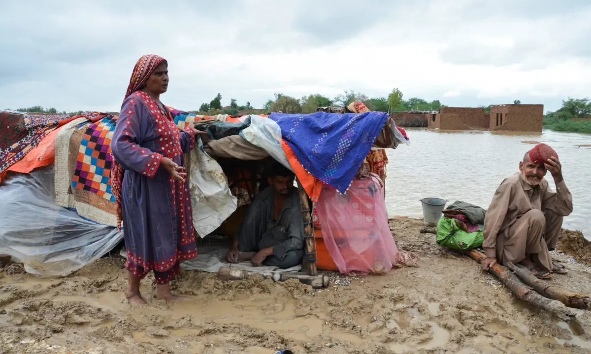 A family takes refuge on a higher ground following rains and floods during the monsoon season in Dera Allah Yar, district Jafferabad, Balochistan, Pakistan, on August 25, 2022. — Reuters