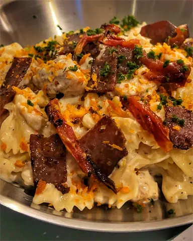   The cowboy pasta that elevates the familiar white sauce pasta with crispy bacon and sundried tomatoes  