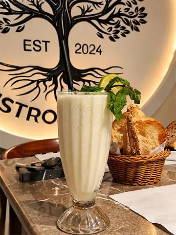 Vanilla frappe with a bread basket in the background