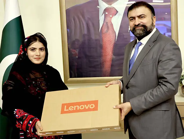   CM Bugti gives away a laptop to a student.&mdash;PPI  