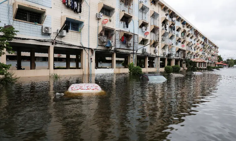 Partially submerged vehicles on a flooded street next to a residential building in Bangkok, Thailand, September 28, 2026. — Reuters