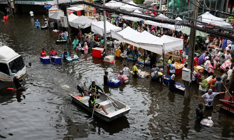 People navigate through a flooded market in Bangkok, Thailand, September 28, 2026. — Reuters