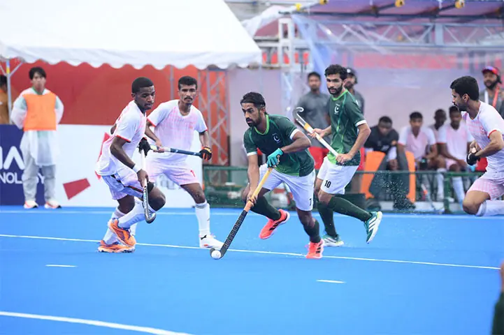  KAKAMIGAHARA: Pakistan&rsquo;s Moin Shakeel carries the ball during the Asian Games hockey match against Oman at the Gifu Prefectural Green Stadium on Monday.&mdash;Courtesy Asian Hockey Federation 