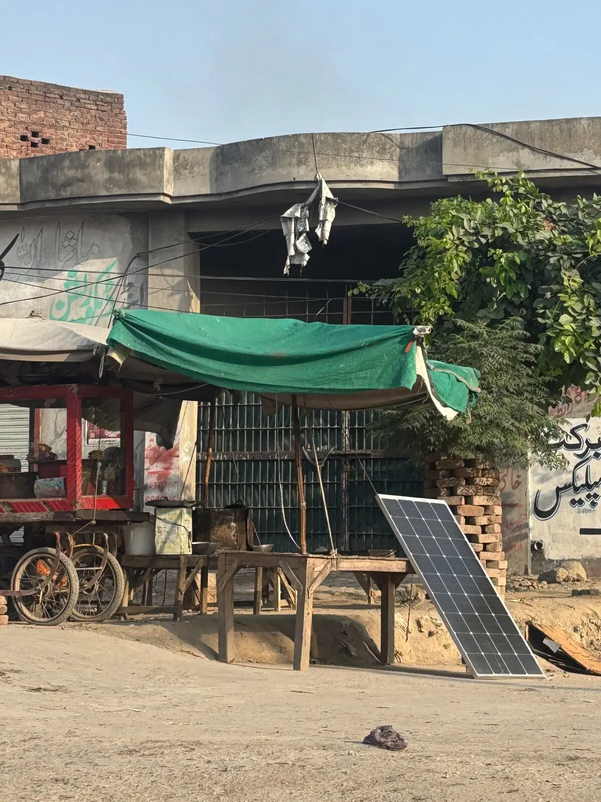 A singular panel propped up by a table in a market in Muzaffargarh