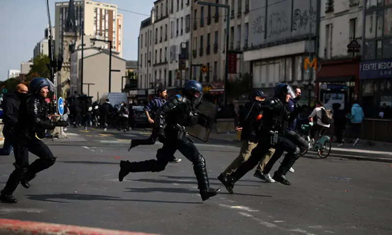 French gendarmes run during clashes amid a student protest outside the Lycee Berthelot in Aubervilliers, near Paris.—AFP/Reuters