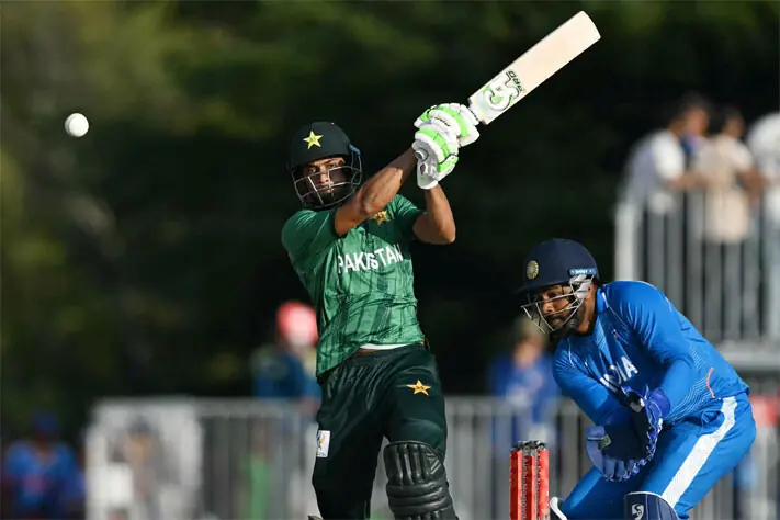 PAKISTAN batter Hasan Nawaz plays a shot as Indian wicket-keeper Sanju Samson reacts during the Asian Games gold medal match at the Korogi Athletic Park on Saturday.—AFP