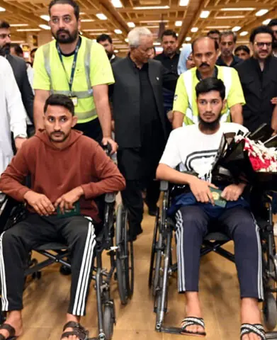   Ameen and Adeel arrive in wheelchairs.&mdash;Shakeel Adil / White Star  