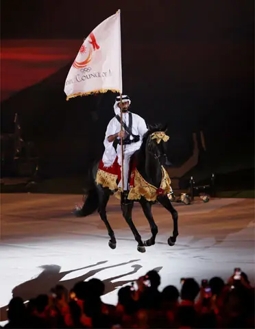 EQUESTRIAN rider Qatar’s Jassim Al Kuwari carries the Olympic Council of Asia flag.—Reuters