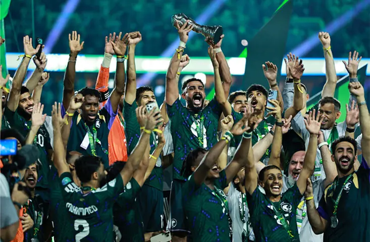 Saudi Arabia players celebrate with the Gulf Cup trophy after beating the United Arab Emirates in the final at the King Abdullah Sports City Stadium.—Reuters