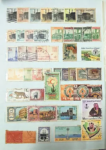 Different stamps of Saudi Arabia being arranged and decorated in a dedicated stamps album