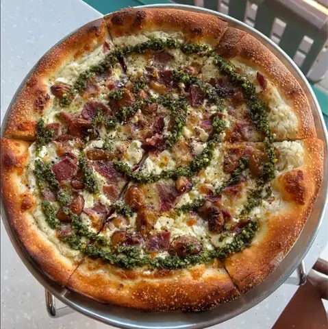   The &lsquo;Market Pizza&rsquo; at Famous O&rsquo;s is topped with roast rib-eye, chimichurri and garlic confit  