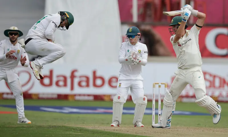 SOUTH AFRICA’S Ryan Rickelton jumps to field a ball played by Australian captain Pat Cummins during the first Test at Kingsmead on Friday.—AFP