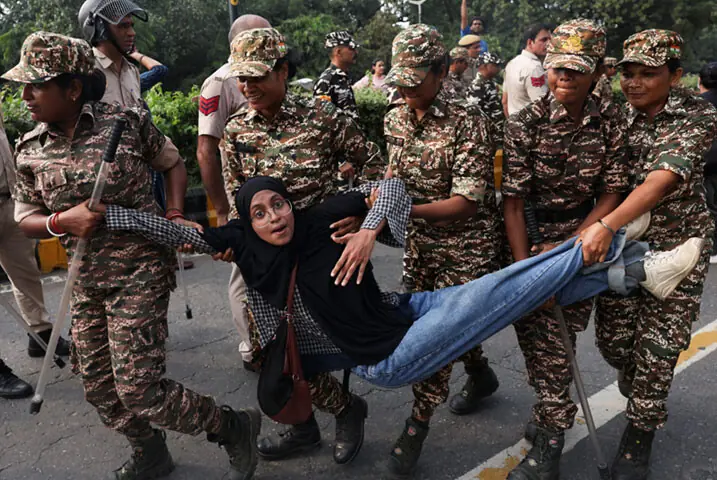  Police detain a protester during a demonstration by the Cockroach Janta Party in New Delhi.&mdash;Reuters 