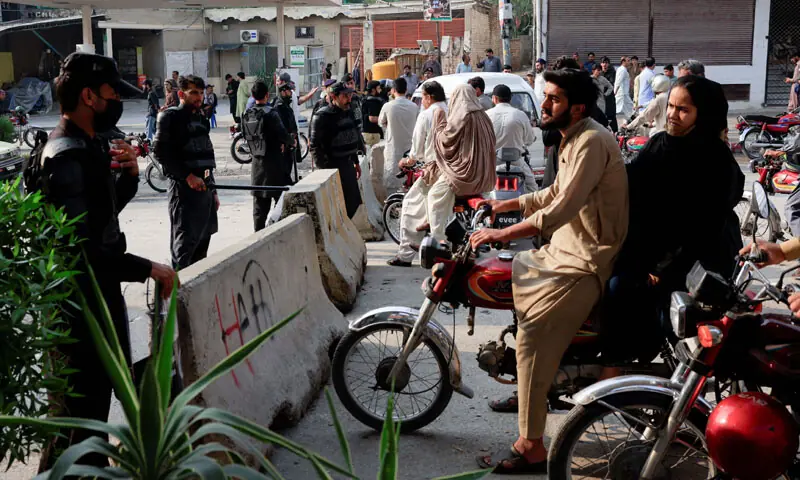  Police guard a road leading to the Red Zone, in Peshawar. &mdash; Reuters 