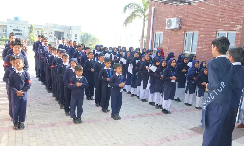 Students listen to recitations from the Holy Quran in the morning assembly.