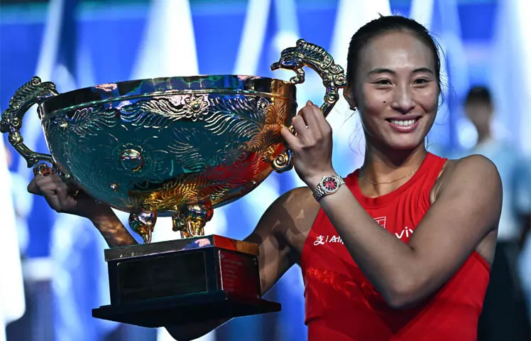 China’s Zheng Qinwen celebrates with the China Open trophy after beating Russia’s Mirra Andreeva in the final on Sunday.—AFP