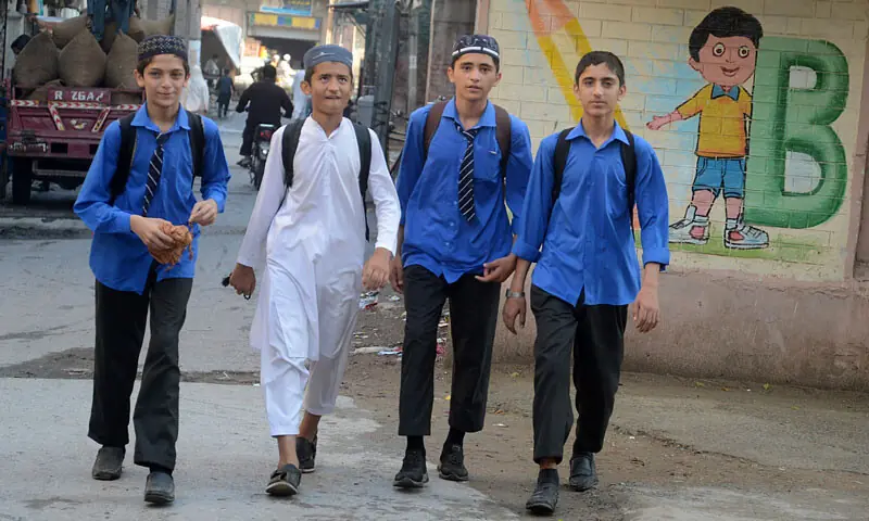 Students return home as educational institutions in Peshawar remained closed. — AFP/Shahbaz Butt
