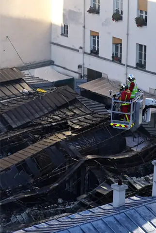    THE destroyed roof of the Marche des Enfants Rouges market in Paris after the fire.&mdash;Reuters   