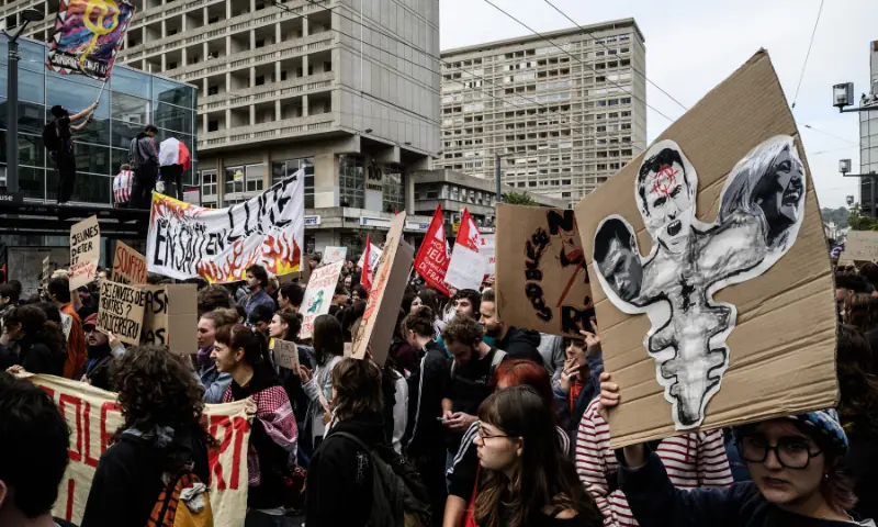 Protesters hold placards and banners during a demonstration of high-school students in Lyon, southeastern France on October 13, 2026, as part of a nationwide high school mobilisation. — AFP