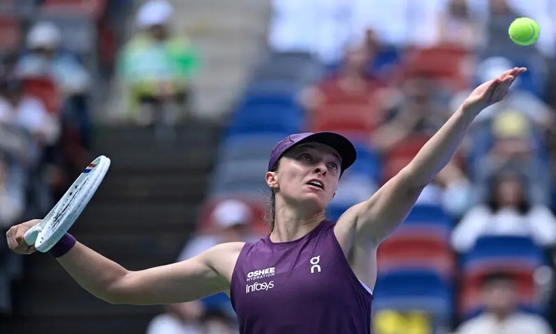 Poland&rsquo;s Iga Swiatek serves to Poland&rsquo;s Magdalena Frech during their Wuhan Open round-of-32 match at the Dongfeng Voyah Centre Court in Wuhan, China, on October 14, 2026. &mdash;AFP